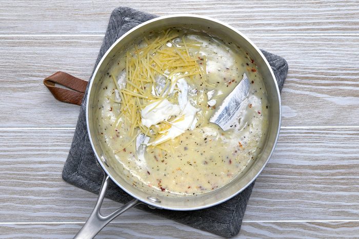 Gradually add the milk, broth and water.