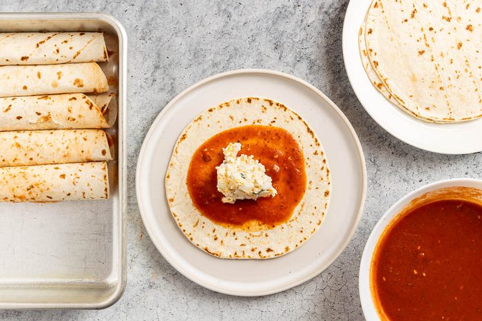 Taste of Home Cheese Enchiladas recipe photo of assembling the enchiladas.