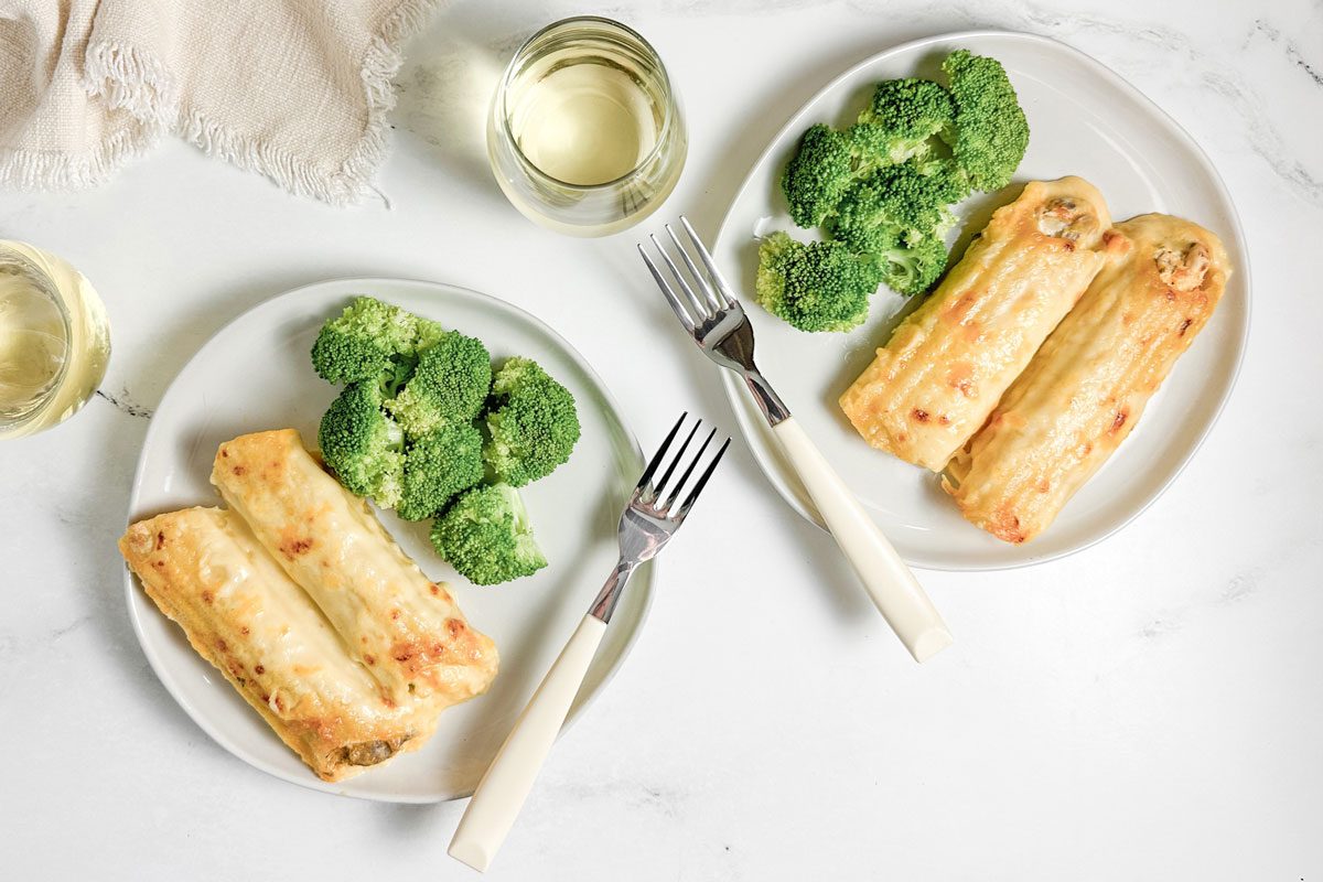 Taste of Home Chicken Manicotti with broccoli on white plates