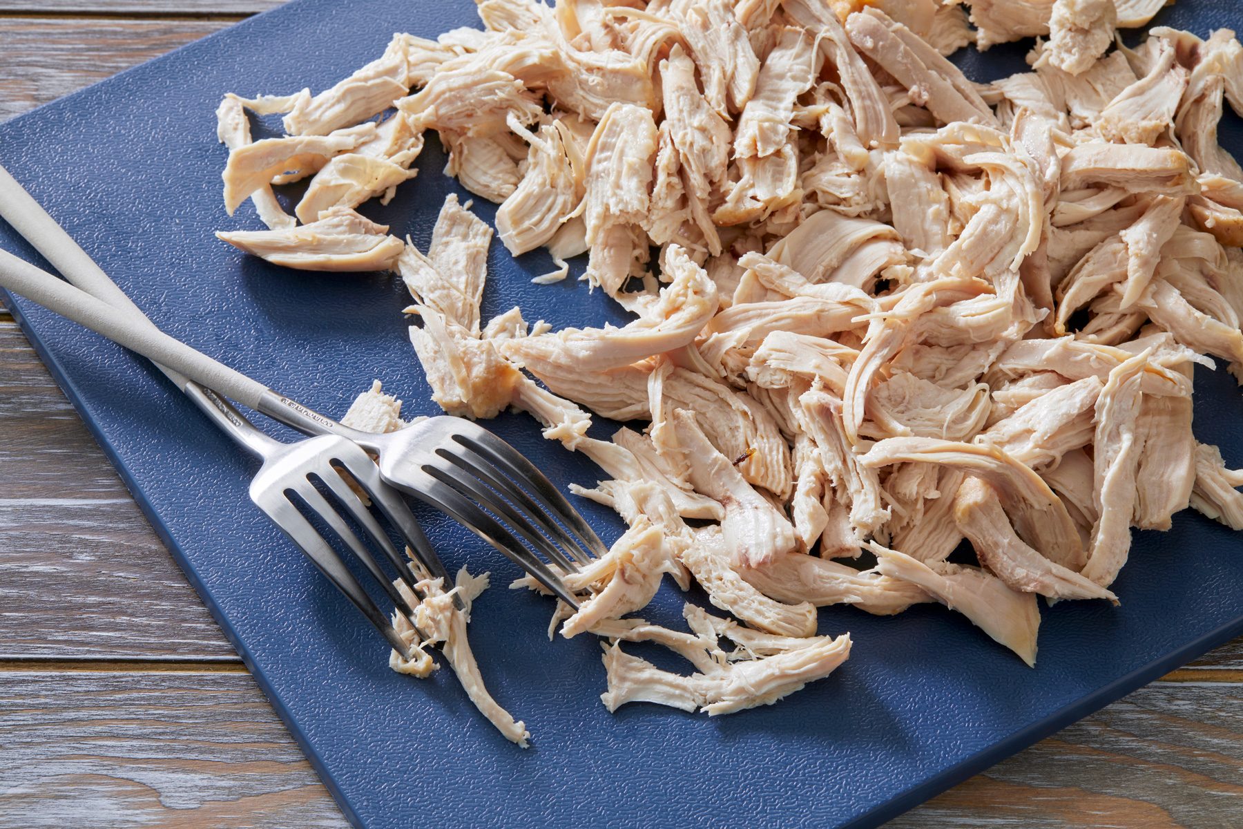 3/4th shot; Removed skin and coarsely shred using 2 forks placed over blue chopping board