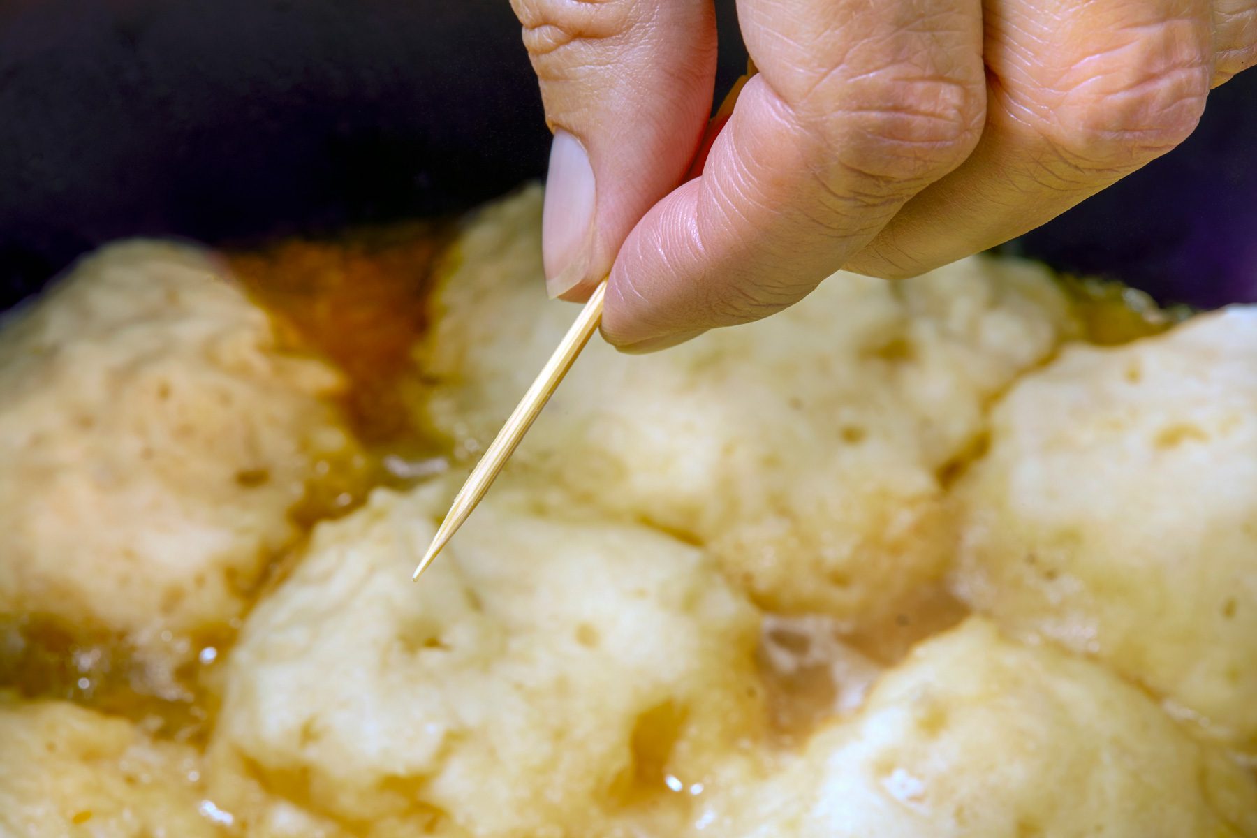 3/4th shot; Inserting toothpick to check for doneness