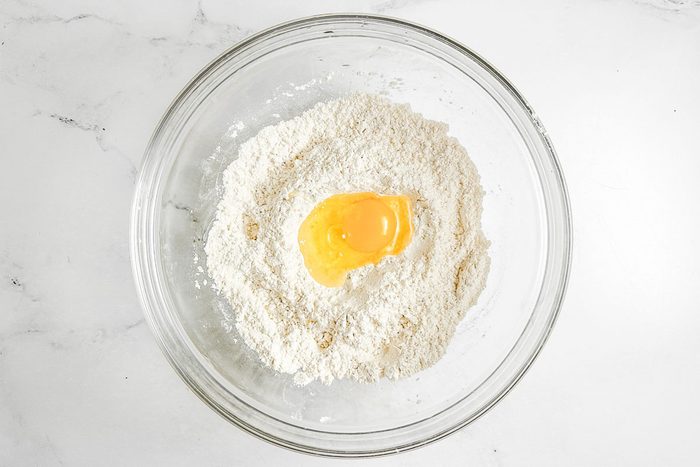 Egg and flour in a glass bowl for Taste of Home Copycat Cracker Barrel Chicken and Dumplings