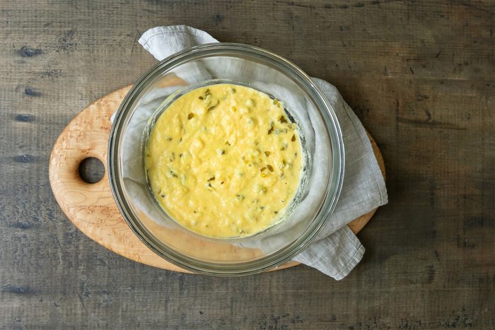 Combining Flour; Cornmeal, Sugar, Baking powder; Salt; Egg; Milk and Oil for topping in a bowl