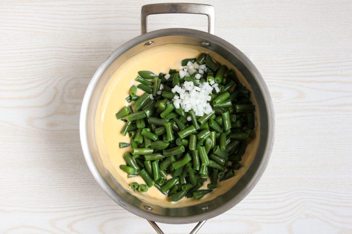Adding green beans and onion to casserole base