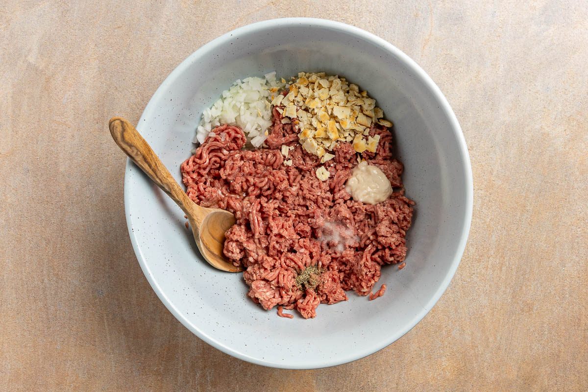 Taste of Home Old Fashioned Salisbury Steak recipe photo of the meat mixture in a large mixing bowl.