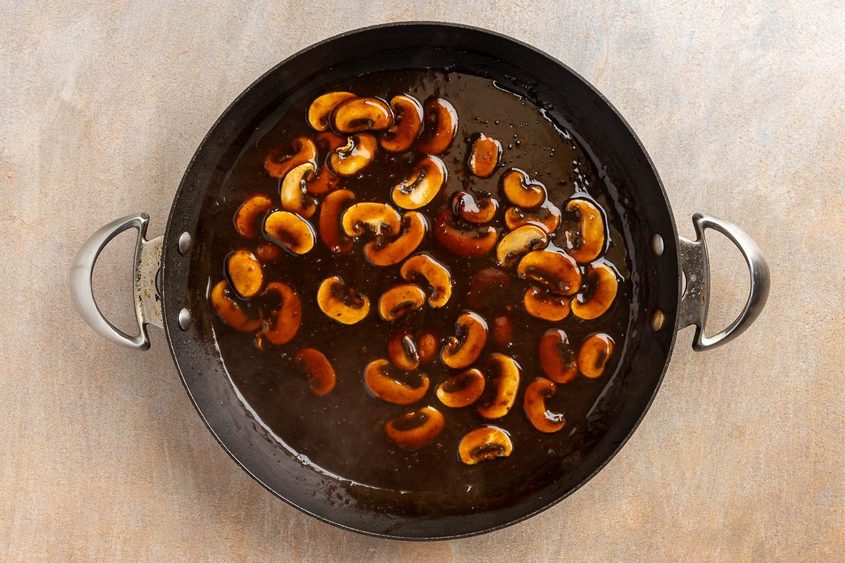 Taste of Home Old Fashioned Salisbury Steak recipe photo of the mushroom gravy in a skillet.