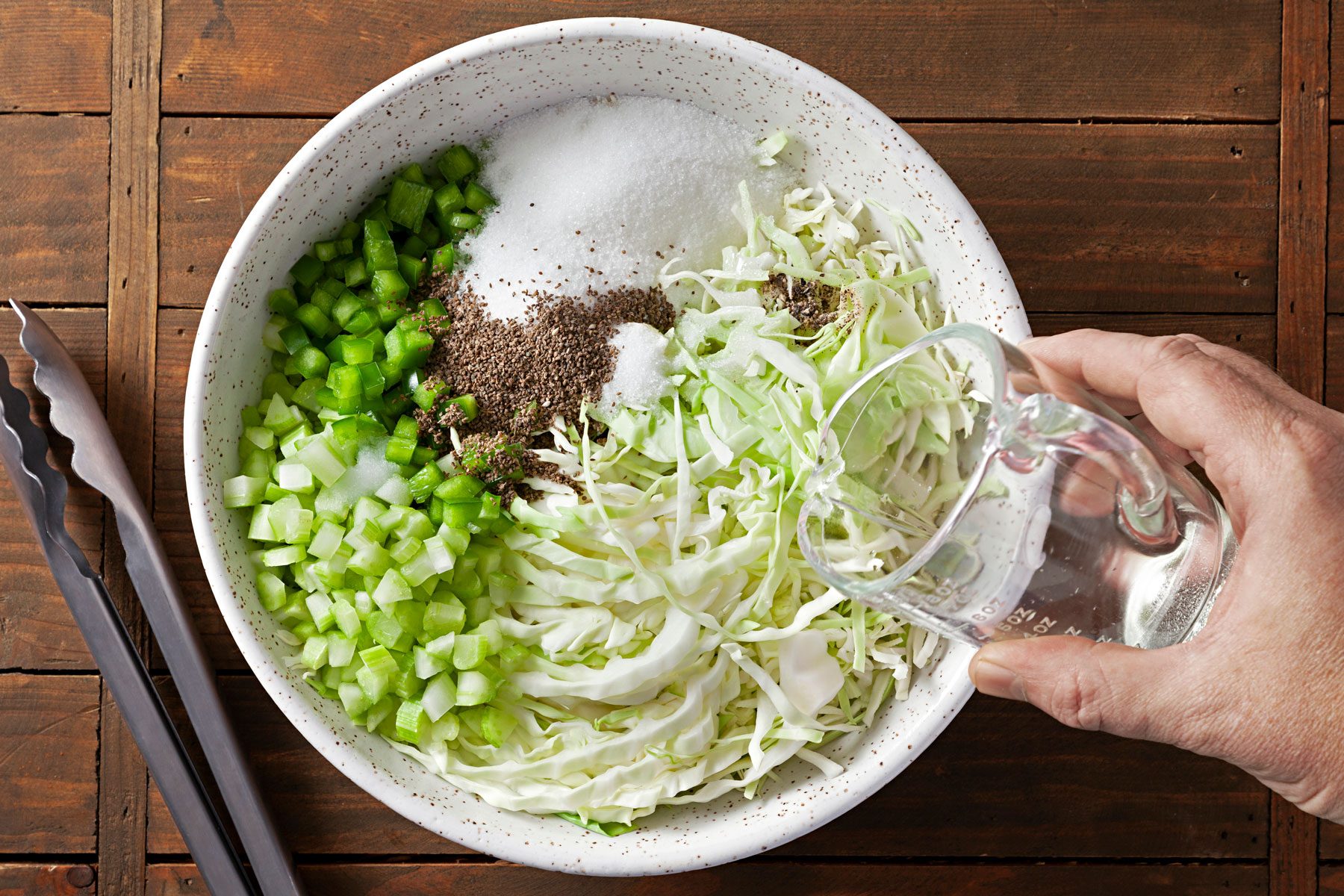 Cabbage, green pepper, celery, sugar, vinegar, celery seed, salt and pepper combined in a large bowl.