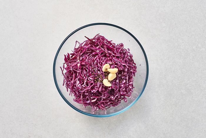 Red cabbage garlic and peppercorns in a large bowl