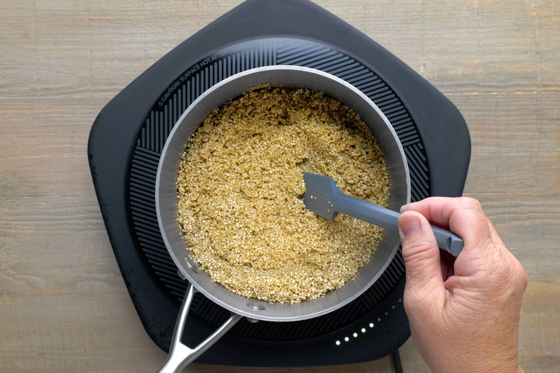 Quinoa being cooked in a large saucepan.