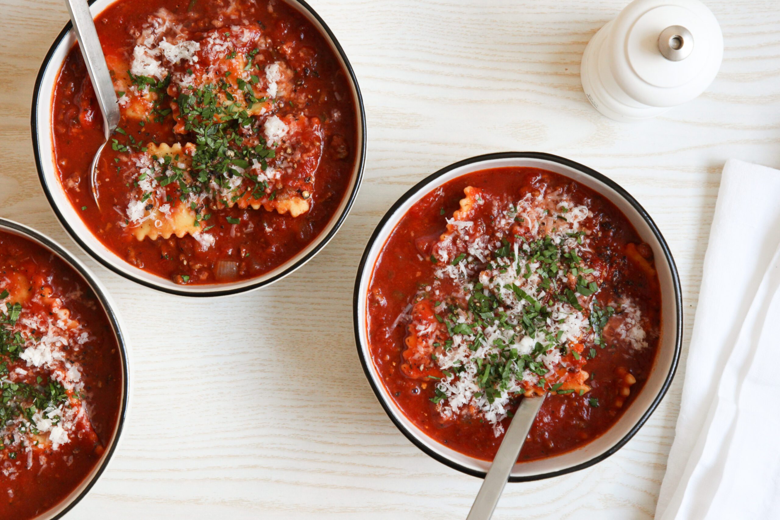 Ravioli Soup topped with parmesan and parsley