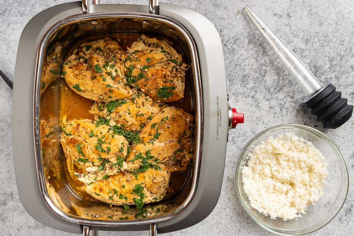 Taste of Home Slow Cooker Lemon Chicken recipe photo of the cooked chicken in the slow cooker with a side of rice.