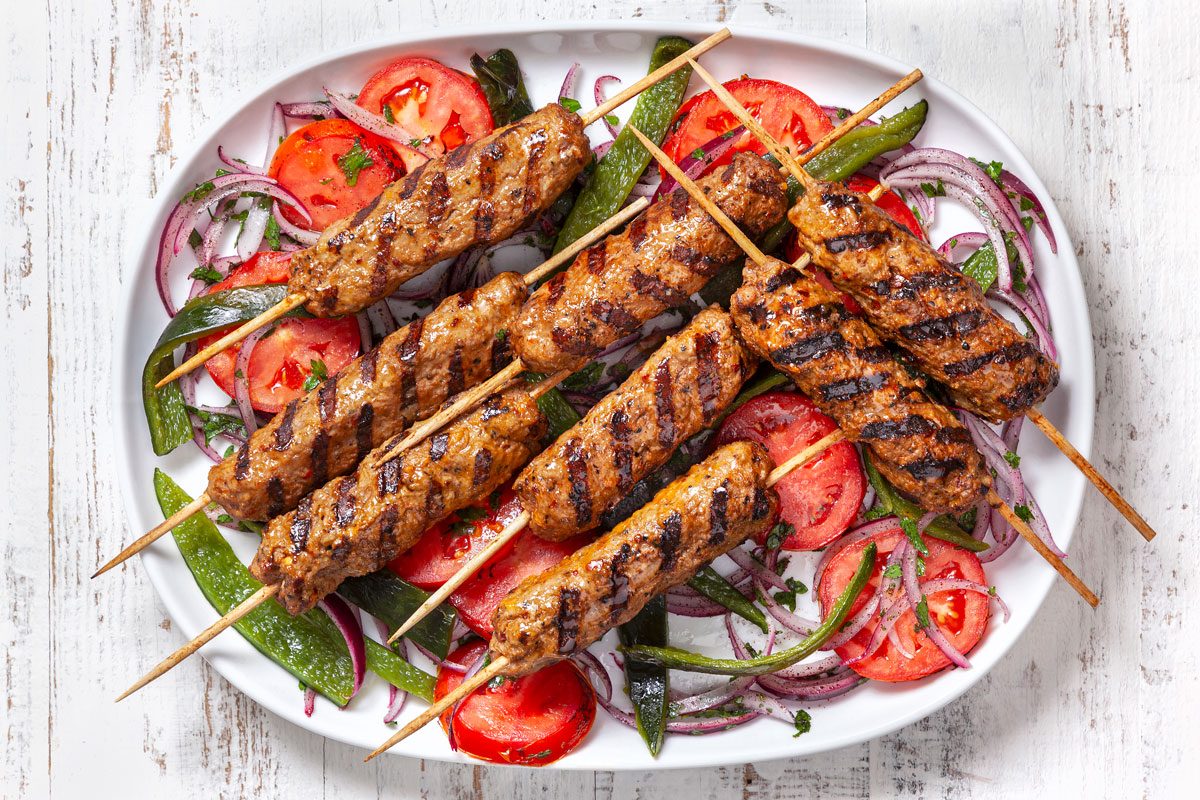 Finished Adana Kabobs arranged on a platter