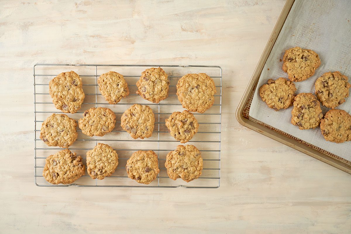 Overhead view of the fully cooked Taste of Home Air Fryer Oatmeal Cookies, cooling on a wire rack, golden brown and ready to serve.