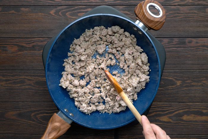 Cook the sausage over medium heat until it's no longer pink