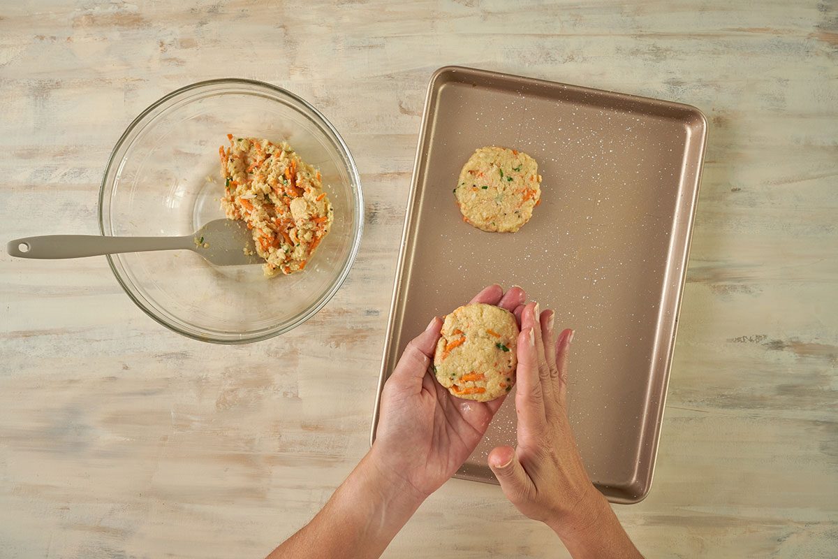 Overhead view of crab cake patties shaped and placed on a plate, ready to chill in the refrigerator for the Taste of Home Baked Crab Cakes recipe.