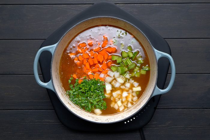 Added carrots, celery, onion and parsley into large saucepan