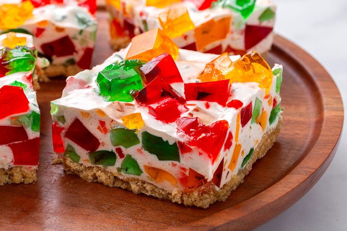 A slice of Broken Glass Jello of a wooden serving platter for Broken Glass Jello recipe for Taste of Home