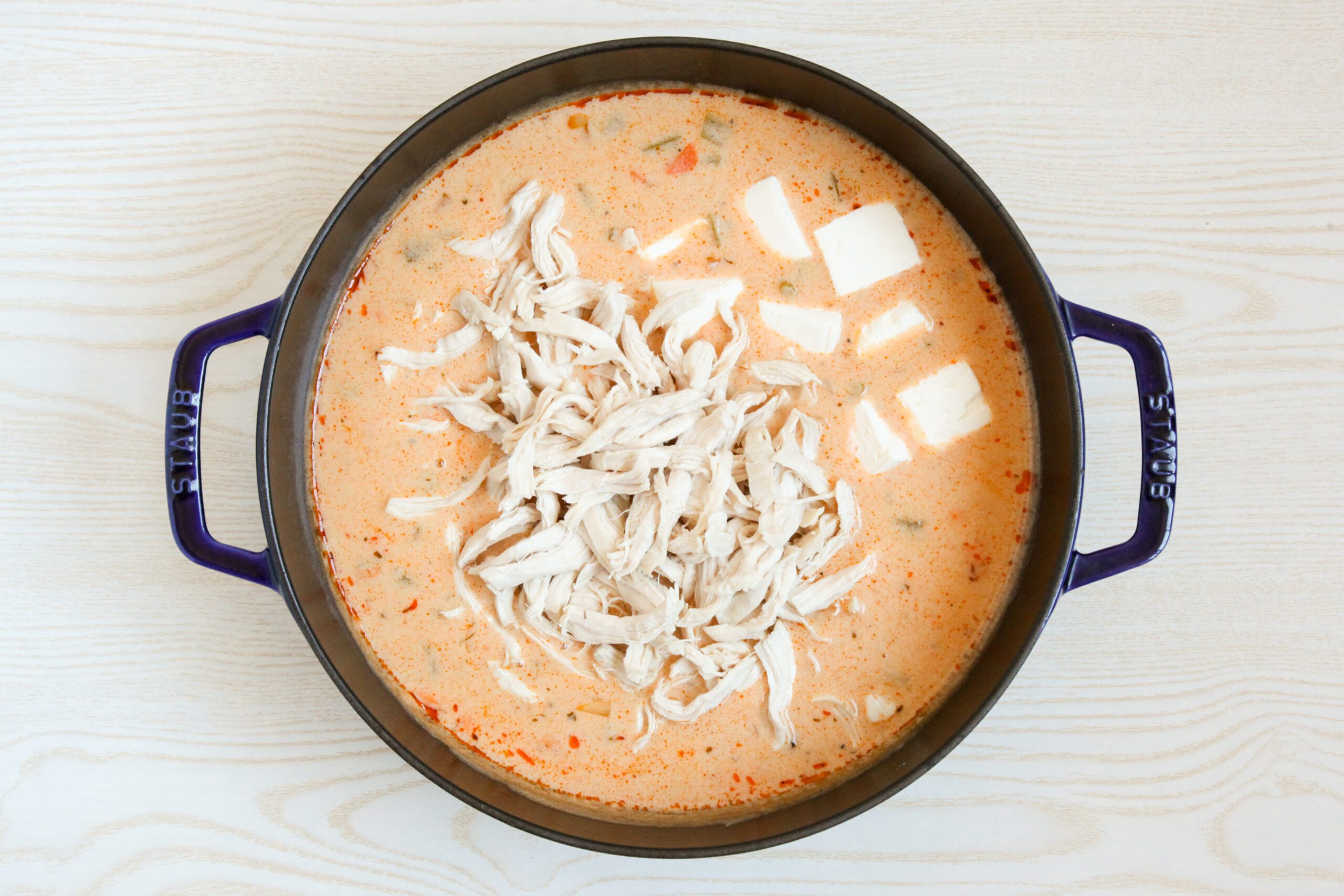 Adding chicken and cream cheese to buffalo chicken soup