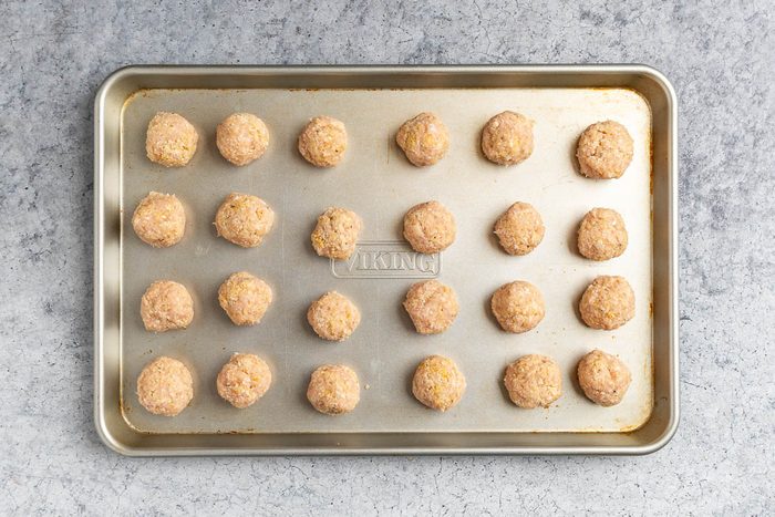 prepped meatballs on a baking sheet