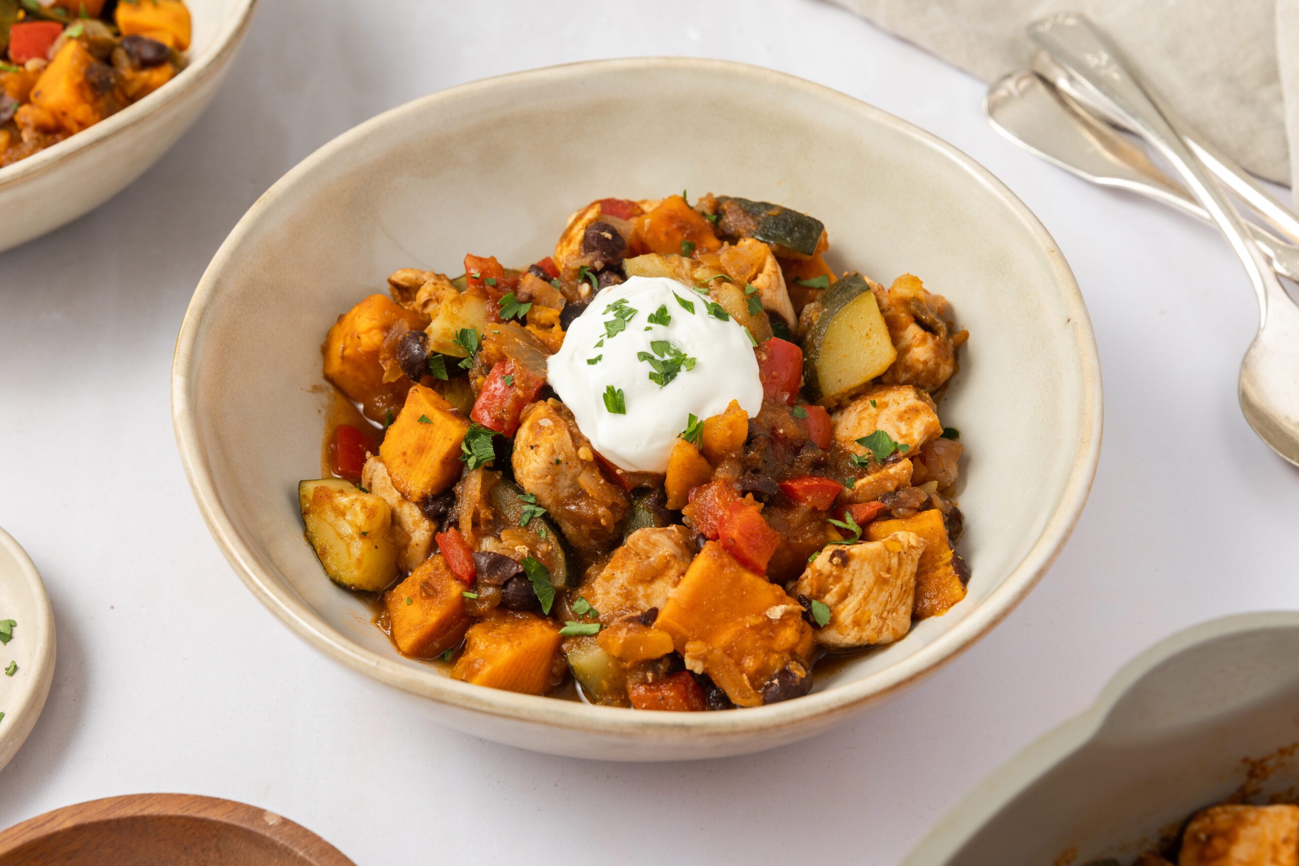 Chicken sweet potato skillet ready and served in bowls.