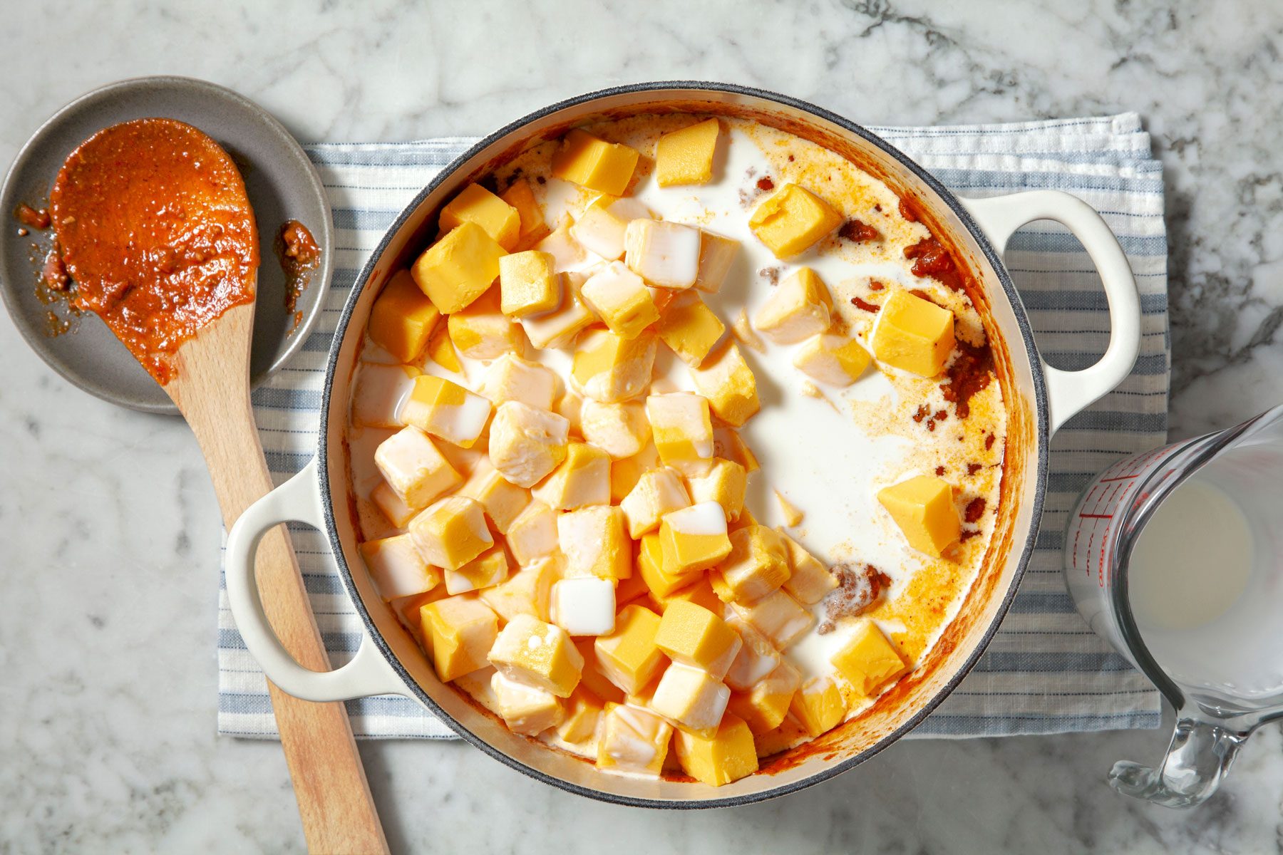 Cheese and cream added to tomato sauce, beans, beef, tomatoes and chili mix.