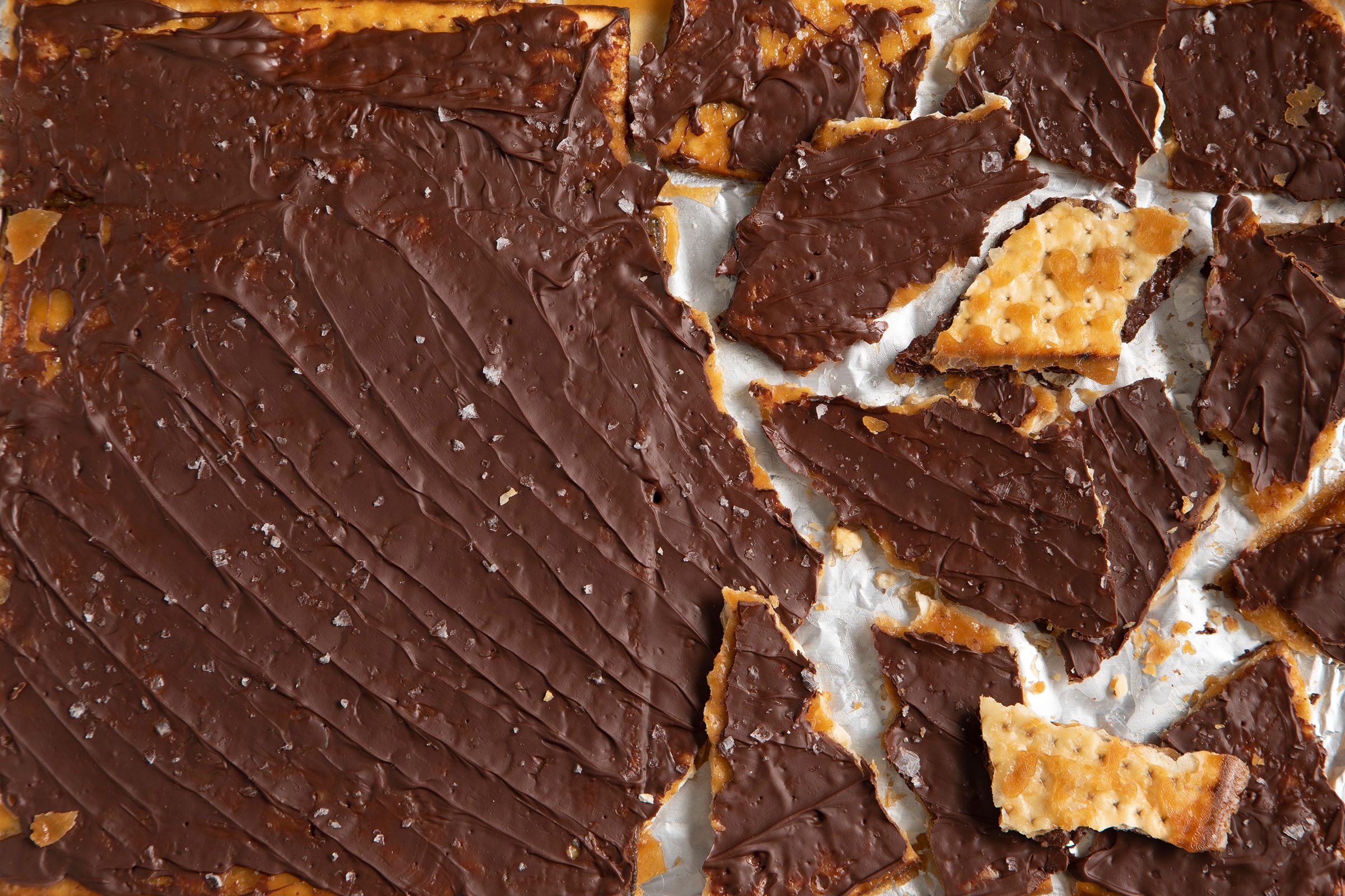 Chocolate Covered Matzo bar broken into little pieces