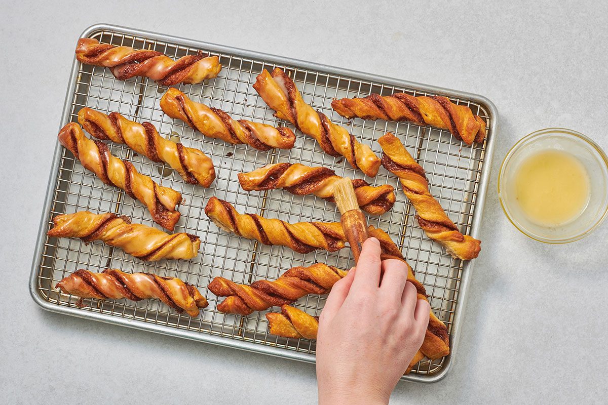 Brushing the glaze over the warm twists
