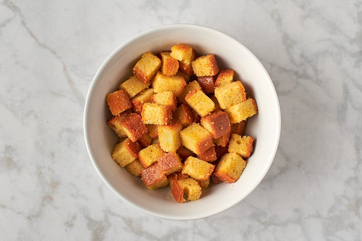 Combine oil, seasonings, and bread cubes