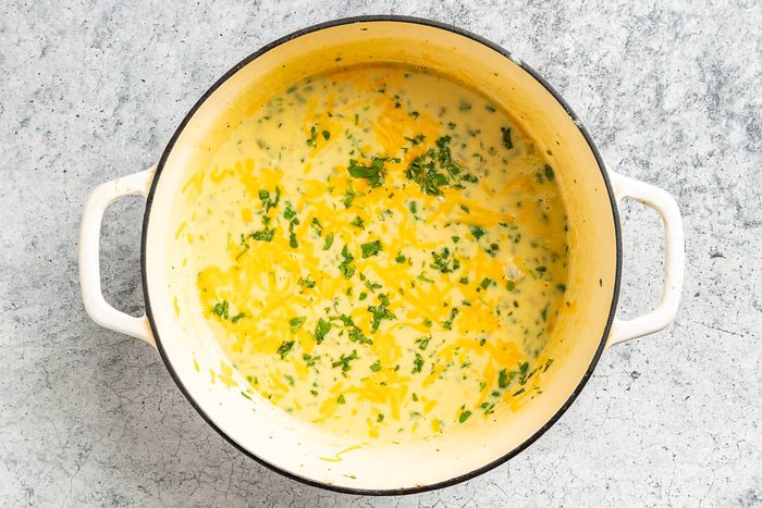 Taste of Home Cream of Jalapeno Soup photo of cooked soup topped with cheese and fresh cilantro.