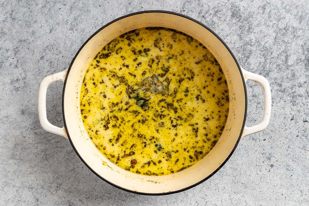 Taste of Home Cream of Vegetable Soup photo combining all the ingredients and cooking in a Dutch oven.