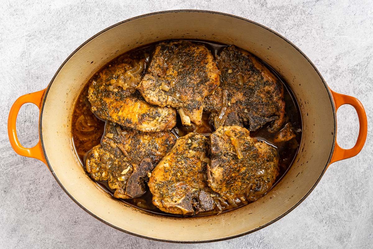 Taste of Home Dutch Oven Pork Chops photo of the braised pork chops in the Dutch oven.