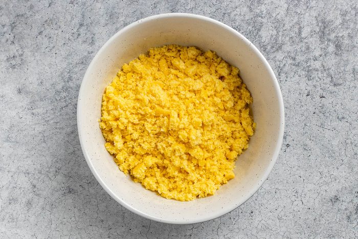 crumbled cornbread in a large mixing bowl.