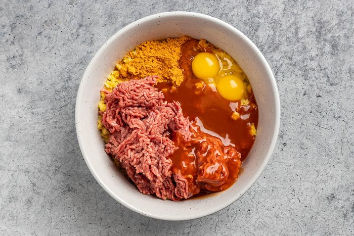meatball ingredients added to the mixing bowl.