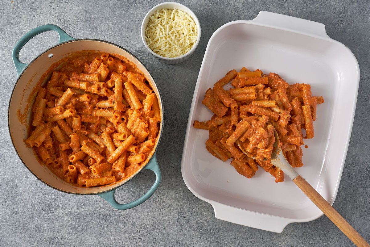 Combine the cooked ziti with the melted cheese sauce, then pour into a greased baking dish and top with mozzarella for the Five-Cheese Ziti by Taste of Home.