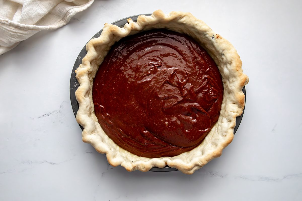 Overhead shot for Taste of Home Fudge Pie, fudge filling in pie crust before baking.