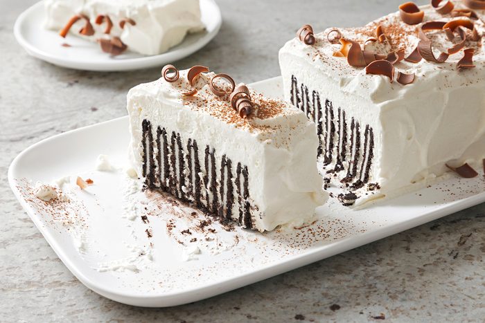 3/4th shot of icebox cake topped chocolate curls and cocoa powder