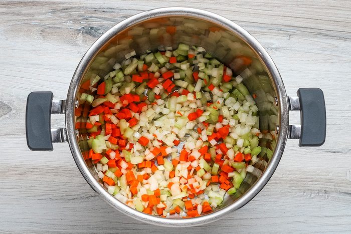 The aromatic vegetables in the Instant Pot to be sautéed for lentil soup.
