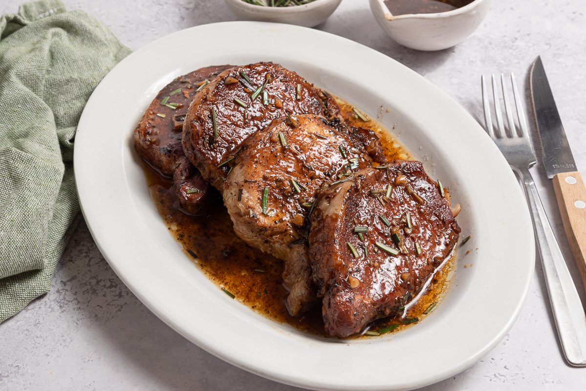 Instant Pot Pork Tenderloins On A Serving Plate With Sauce