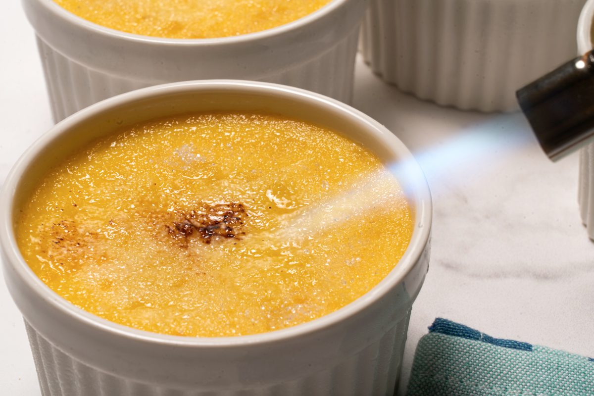 Caramelizing the sugar with a torch_Photo by Orly Catz for Taste of Home