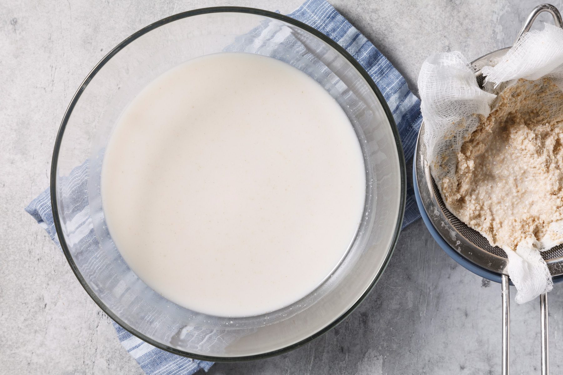 A large glass bowl filled with Oat Milk