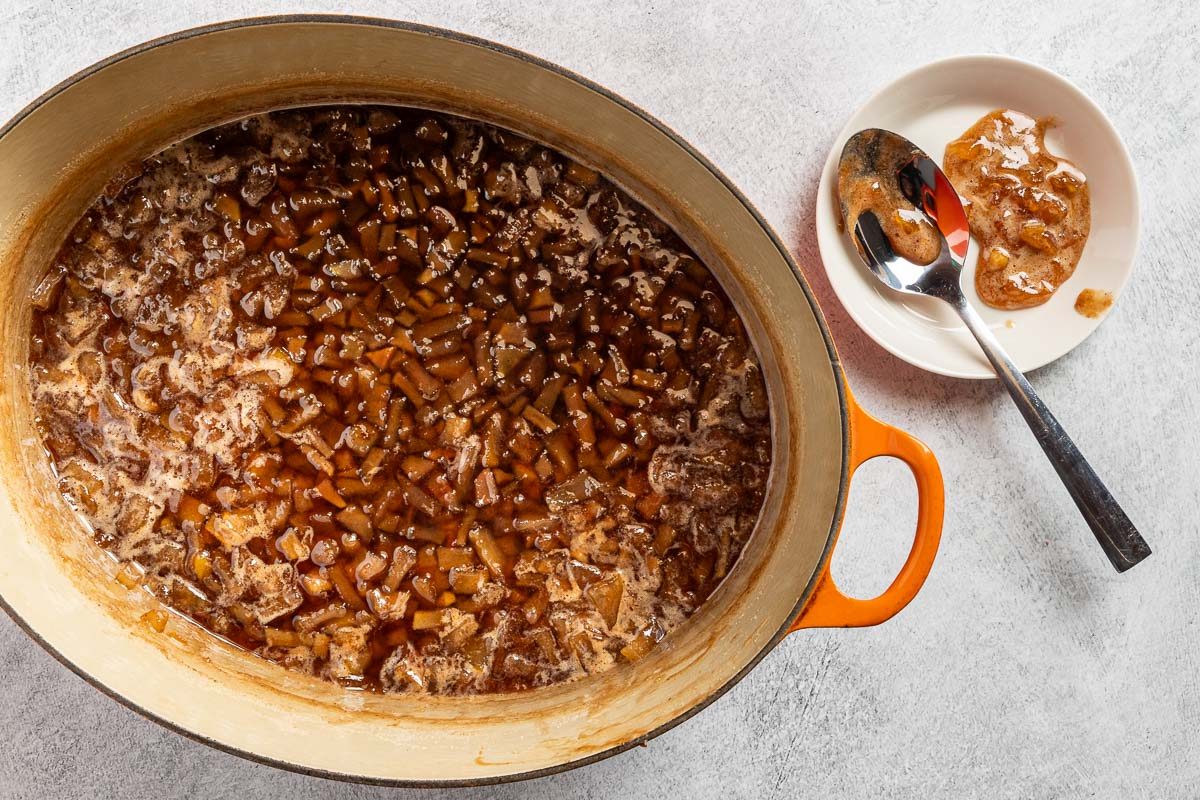 skimming off the foam from the cooked jam.