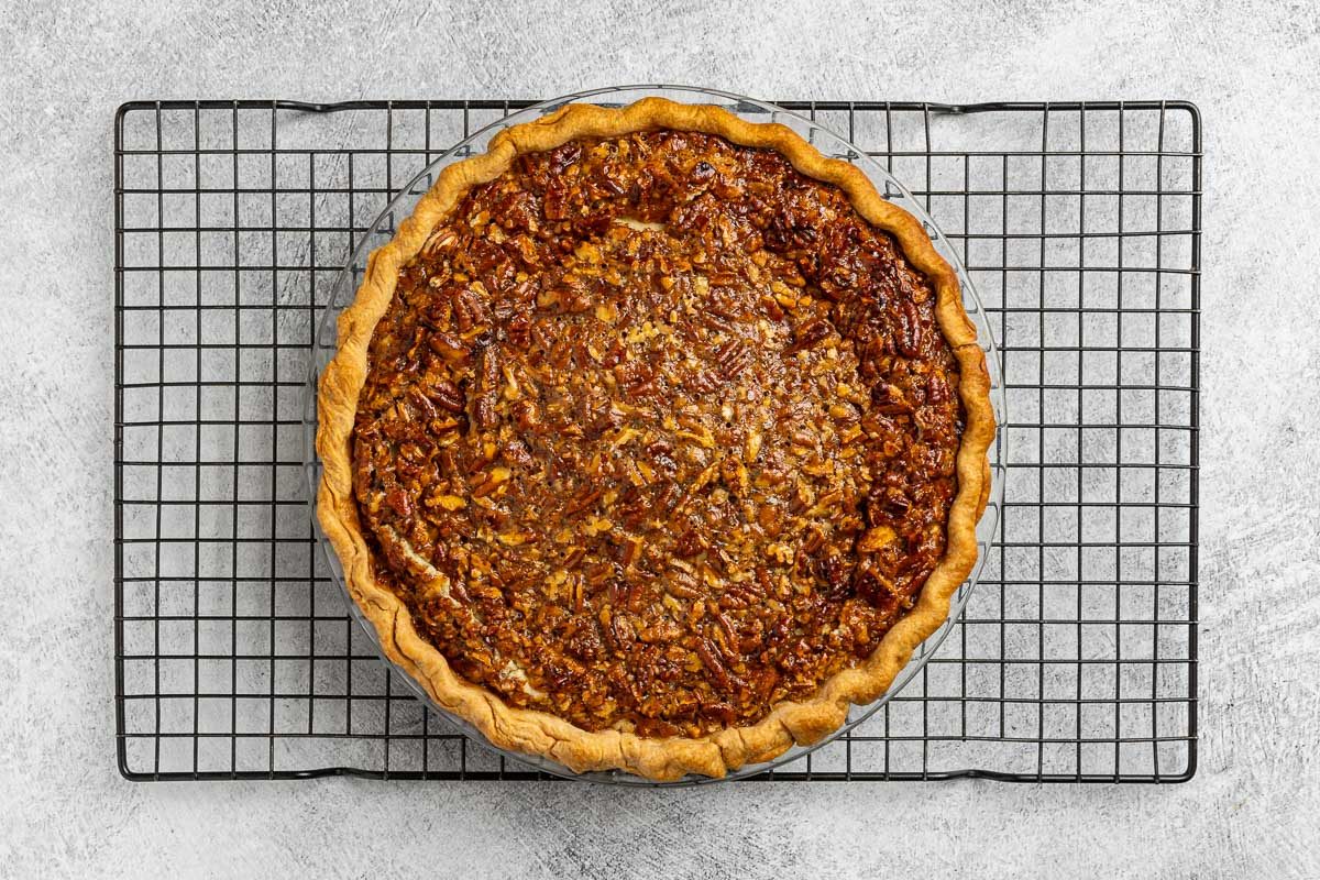 baked cheesecake cooling on a rack.