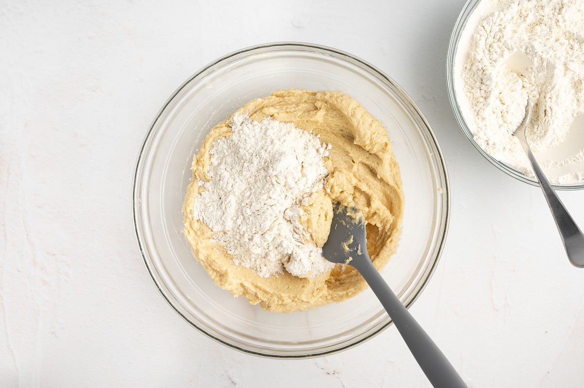 adding dry ingredients to wet ingredients for pinwheel cookies