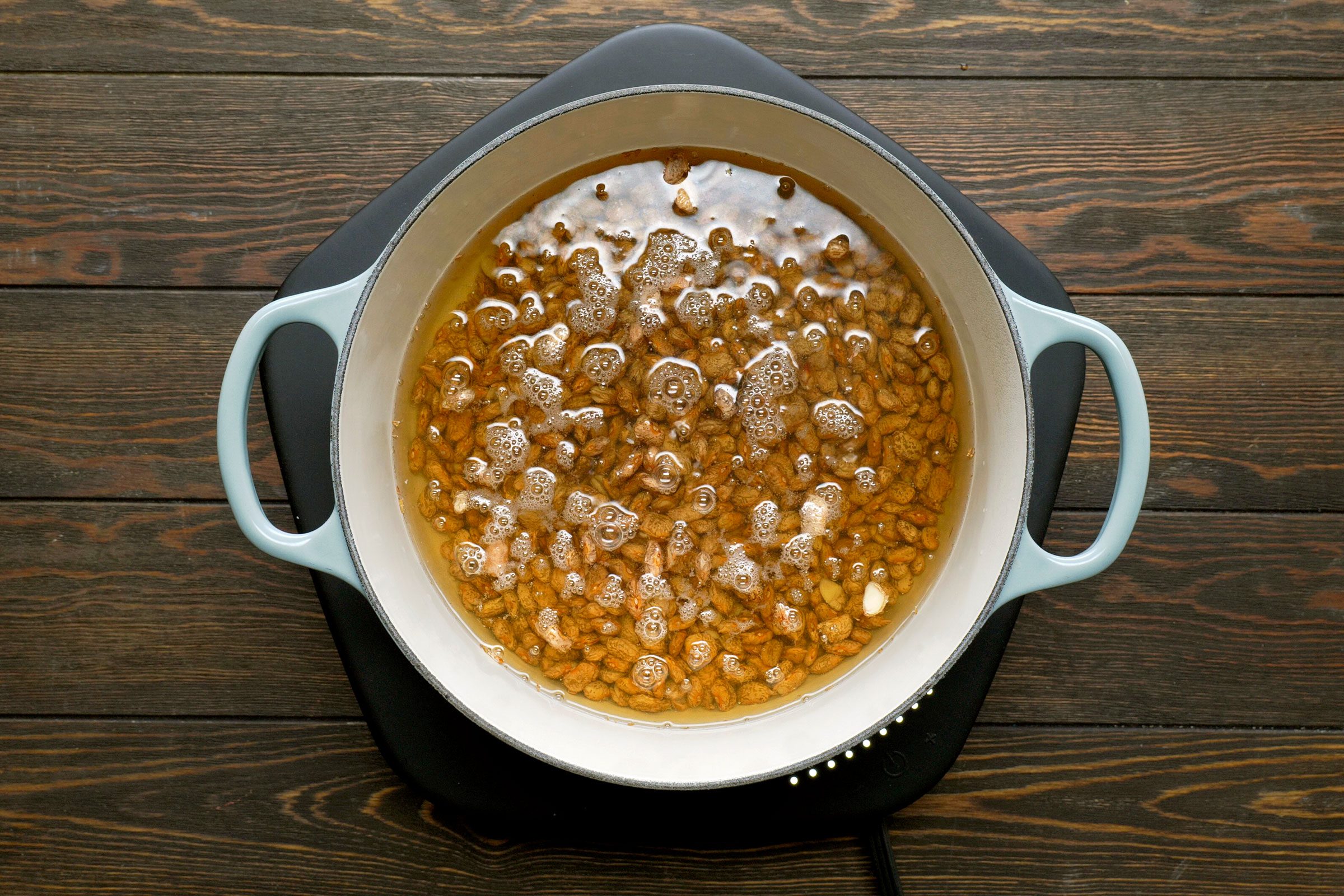 Boiling beans dipped in water in a dutch oven 