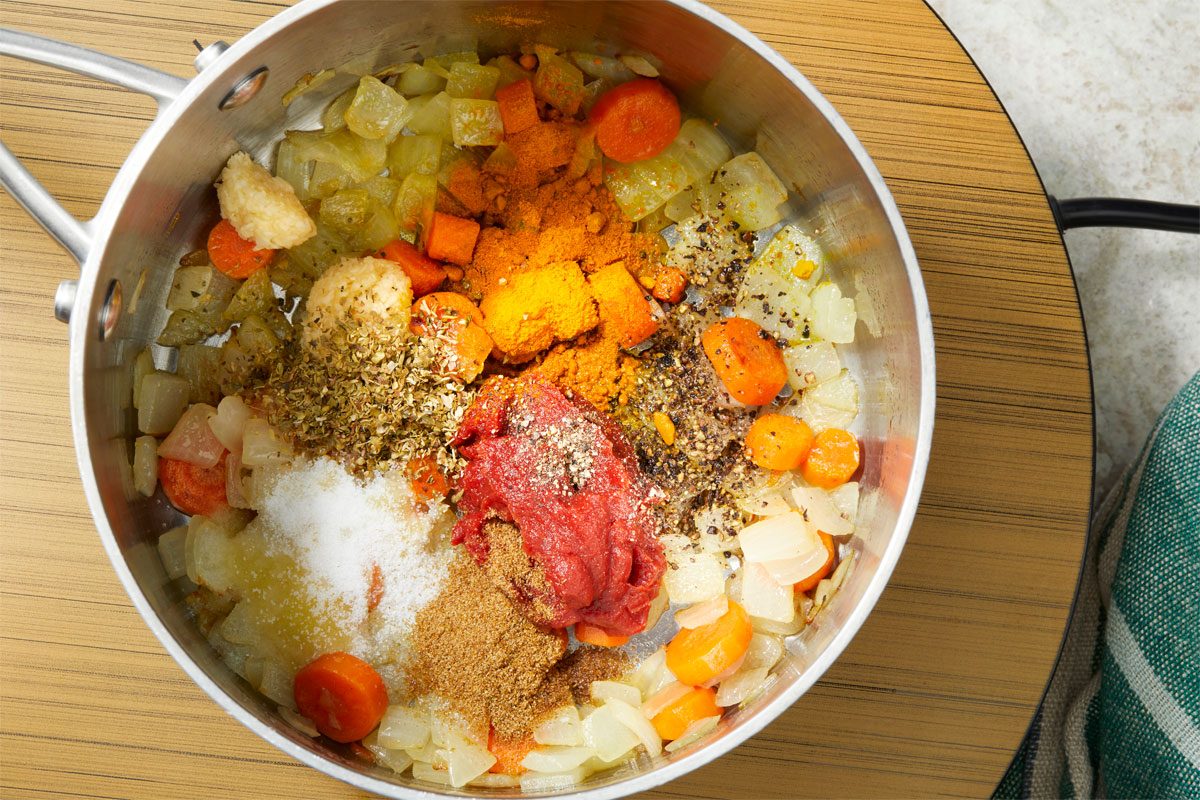 Add garlic; salt; cumin; oregano; turmeric; pepper and tomato paste