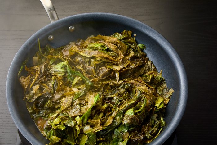 Cooking Sauteed Collard Greens in an open skillet