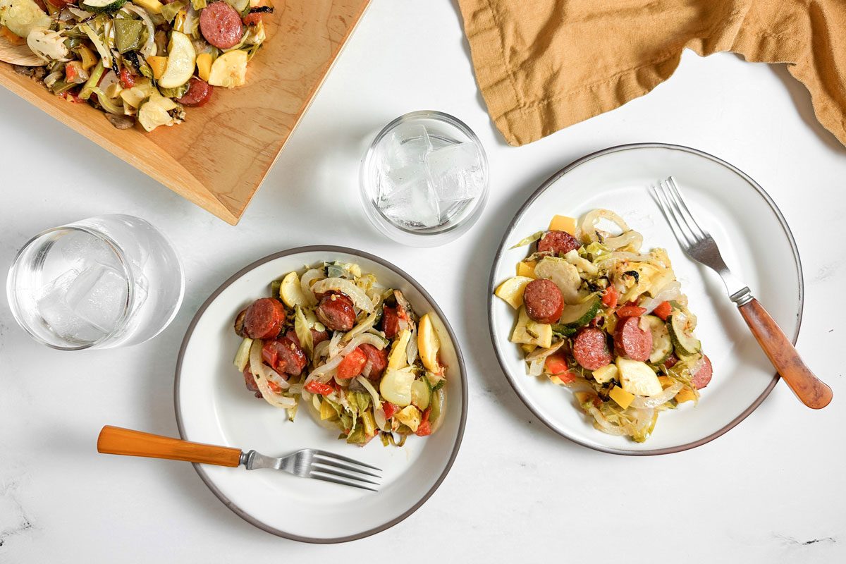 Taste of Home Sheet Pan Sausage and Veggies on white ceramic plates