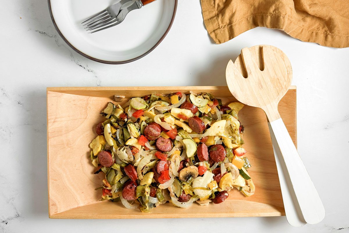Taste of Home Sheet Pan Sausage and Veggies in a wooden serving bowlSausage And Veggies In A Wooden Serving Bowl