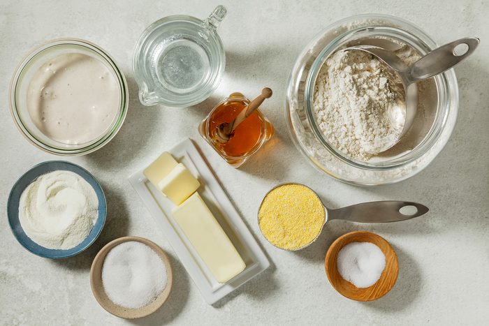 overhead shot of Sourdough English Muffins ingredients placed over white background