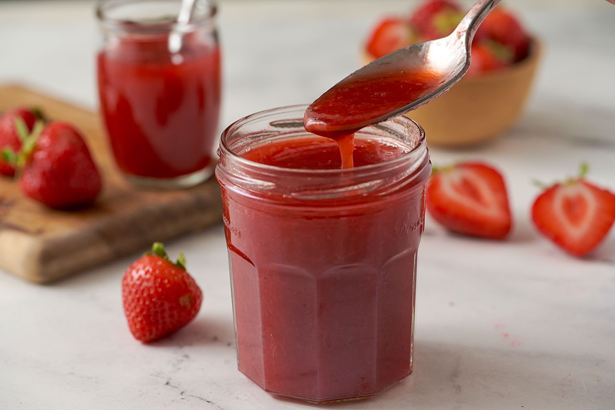 A close-up shot of the Strawberry Syrup, highlighting its smooth, thick texture and rich color, by Taste of Home.